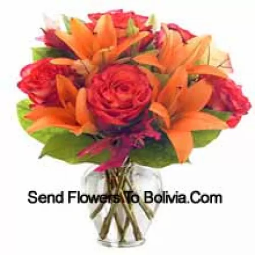 Оранжевые лилии и оранжевые розы с сезонными наполнителями, красиво составленные в стеклянной вазе