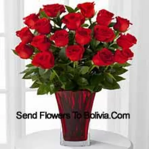 19支红玫瑰与季节性填充物，装在玻璃花瓶中，搭配粉色蝴蝶结装饰